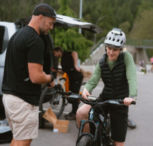 Nico Maybury from Gloworm Lights team setting up Hannah Hamilton's bike before the shoot in the Redwoods.