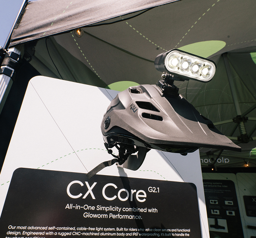 Gloworm CX Core Light System (G2.1) mounted on a helmet at the Gloworm Lights booth, Sea Otter Classic 2026.